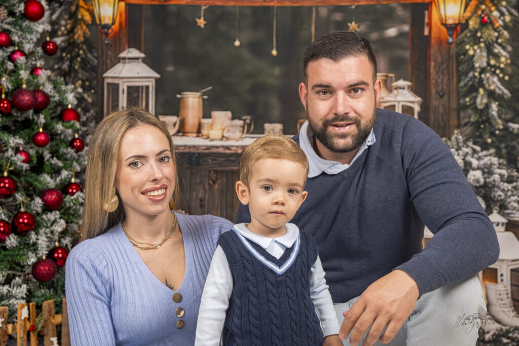 Niño de pie con apoyo de adulto en sesión navideña en Dos Hermanas